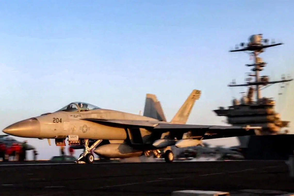 TOPSHOT - This grab from footage shared by the US Central Command (CENTCOM) on March 15, 2025 shows a US F/A-18 fighter aircraft taking off from an aircraft carrier at sea reportedly amidst operations launched against Huthis in Yemen. Strikes hit Yemen's Huthi-held capital Sanaa on March 15, the rebels' Al-Masirah TV said, after US President Donald Trump announced military action. "An American-British aggression raided a residential neighbourhood in the Shuub district, north of the capital, Sanaa," Al-Masirah said. There was no immediate comment from British authorities. (Photo by DVIDS / AFP)