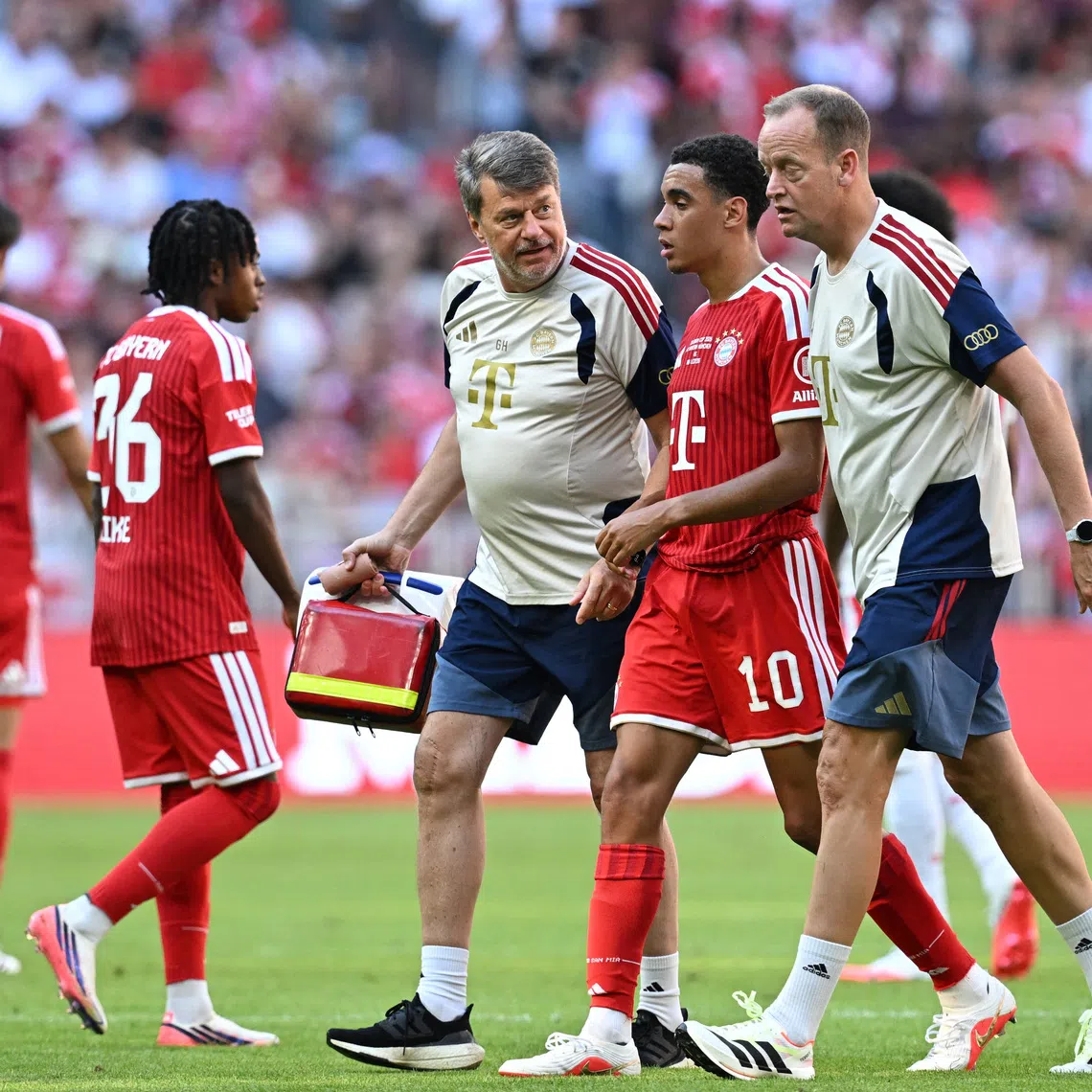 Soccer Football - Pre Season Friendly - Bayern Munich v RB Leipzig - Allianz Arena, Munich, Germany - August 15, 2026 Bayern Munich's Jamal Musiala walks off the pitch to be substituted after sustaining an injury REUTERS/Angelika Warmuth