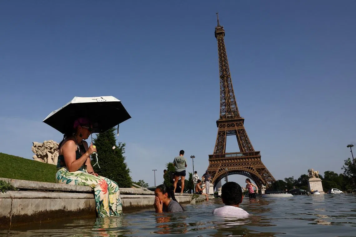 People cool off in the Trocadero fountain in front of the Eiffel Tower as temperatures rise in Paris during a heatwave affecting a large part of France, June 23, 2026. REUTERS/Abdul Saboor