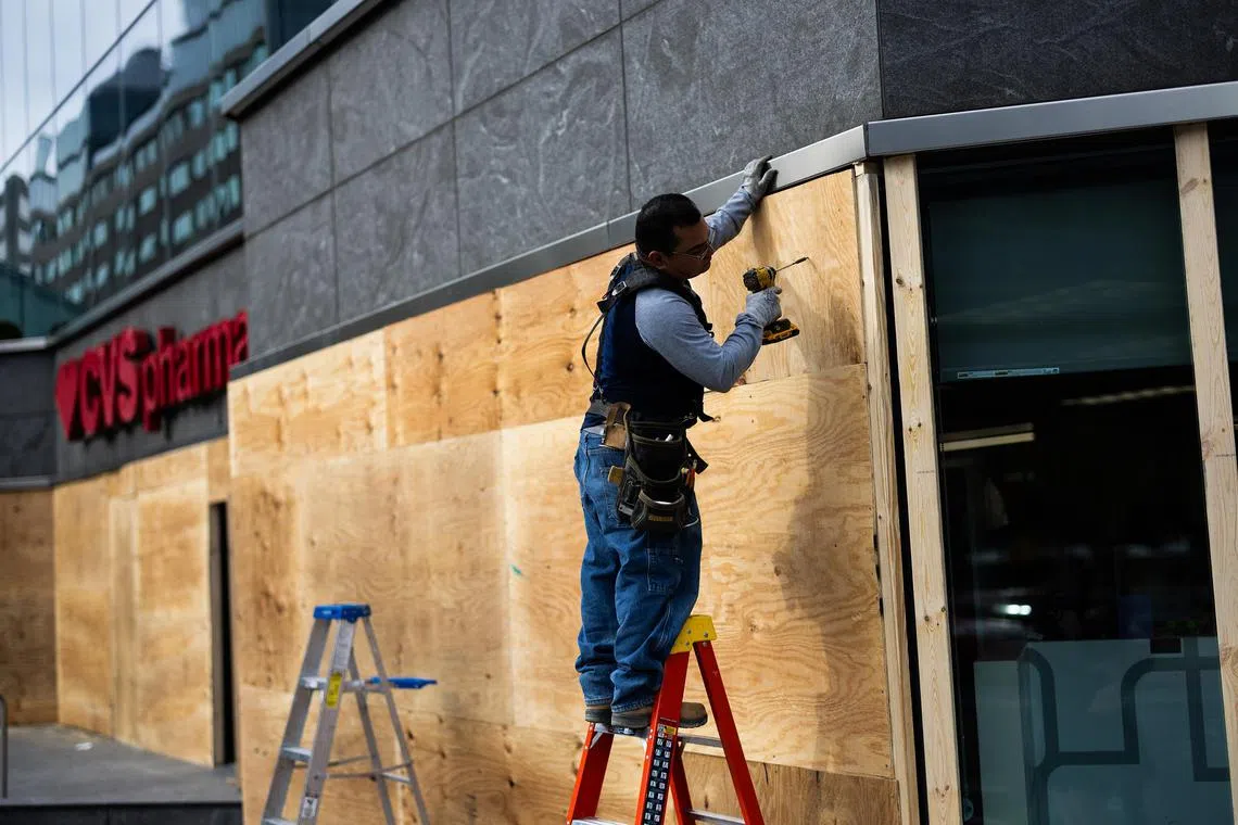 Some storefront windows in Washington, DC, and elsewhere have been covered by plywood.      