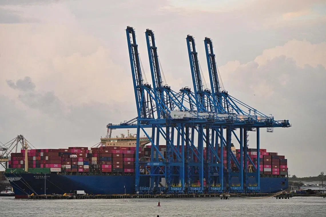 The South Korean cargo ship HMM VICTORY is pictured docked at the Colon port in Colon province, Panama, on February 6, 2026. The subsidiary of Hong Kong-based CK Hutchison, Panama Ports Company (PPC), announced on February 3 that it had initiated international arbitration proceedings against Panama after the Central American country's courts revoked the concession allowing it to operate two ports on the interoceanic canal. (Photo by MARTIN BERNETTI / AFP)