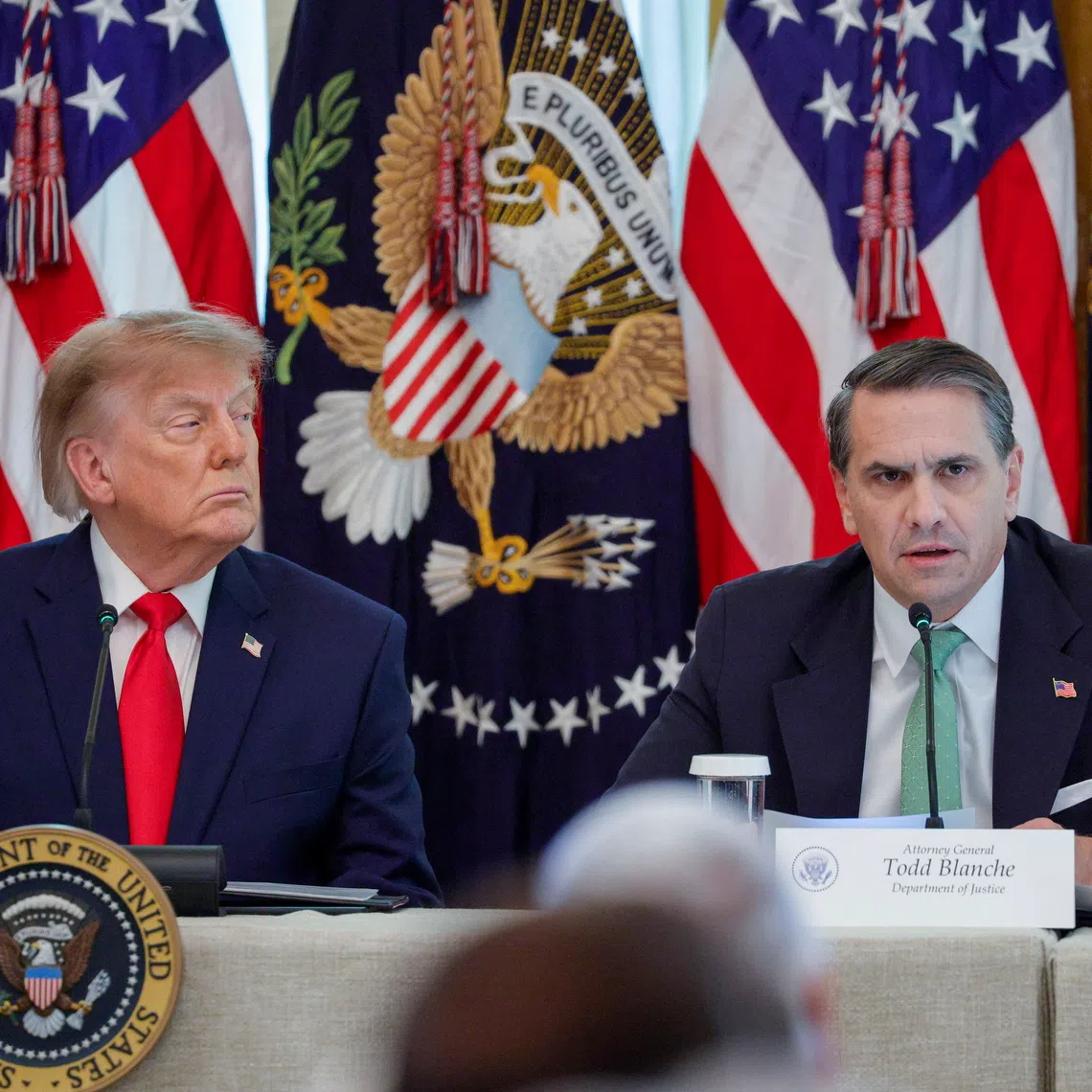 US Attorney-General Todd Blanche (right), with US President Donald Trump, delivers remarks during a roundtable on Protecting American Families and Seniors from Cybercrime in the East Room of the White House in Washington DC, on Oct 21.
