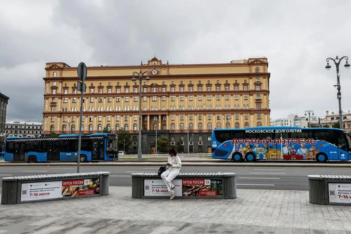 A woman uses her mobile phone in front of the Federal Security Service (FSB) building on Lubyanka Square in Moscow, Russia, June 24, 2023. REUTERS/Maxim Shemetov/file photo