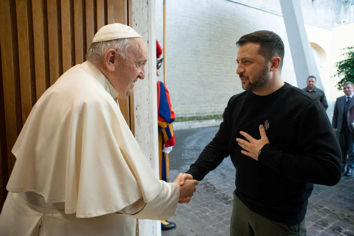 Pope Francis greets Ukrainian President Volodymyr Zelensky upon his arrival for a private audience.