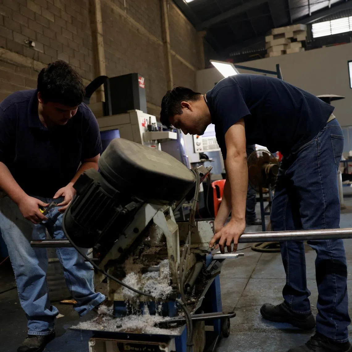 Workers cut a steel bar at a metal-mechanical parts factory in Apodaca, Mexico, March 11, 2025. REUTERS/Daniel Becerril/File Photo
