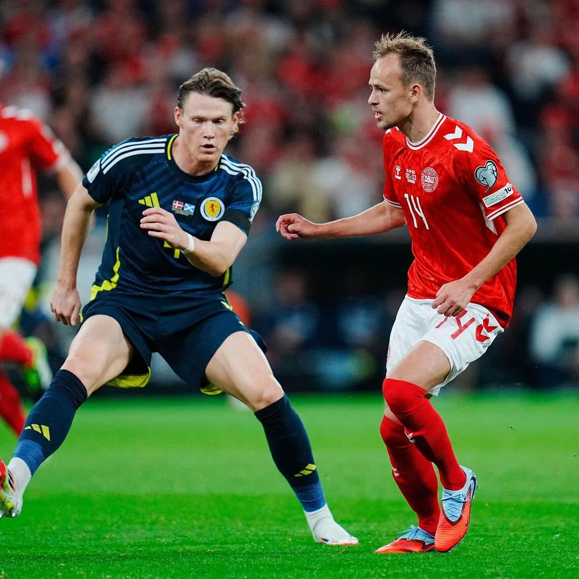 Scotland's Scott McTominay (left) and Denmark's Mikkel Damsgaard vie for the ball during their World Cup qualifier.