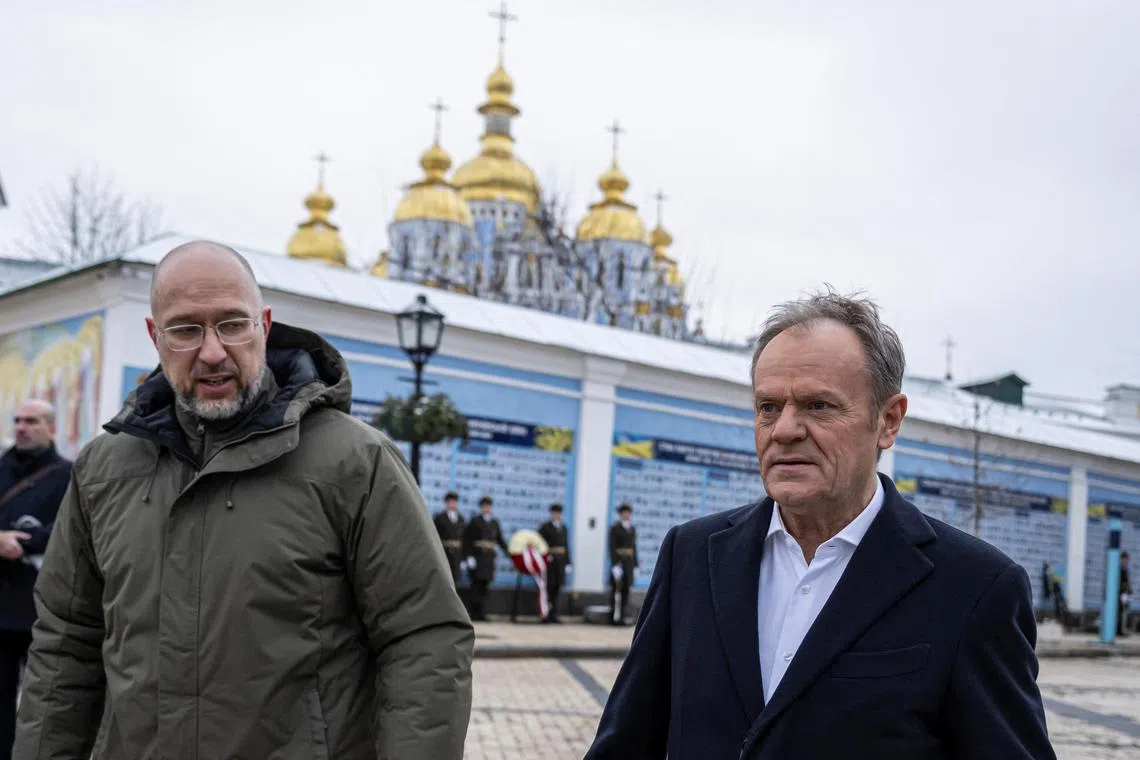 Polish Polish Prime Minister Donald Tusk (right) and his Ukrainian counterpart Denys Shmyhal walk at Mykhailivksa Square after visiting the Memory Wall of Fallen Defenders of Ukraine.