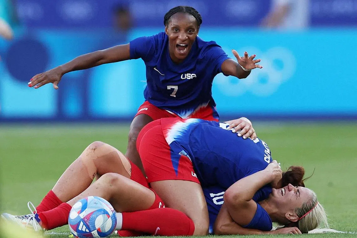 Crystal Dunn of the United States celebrates with teammates after winning gold at the Paris Olympics.