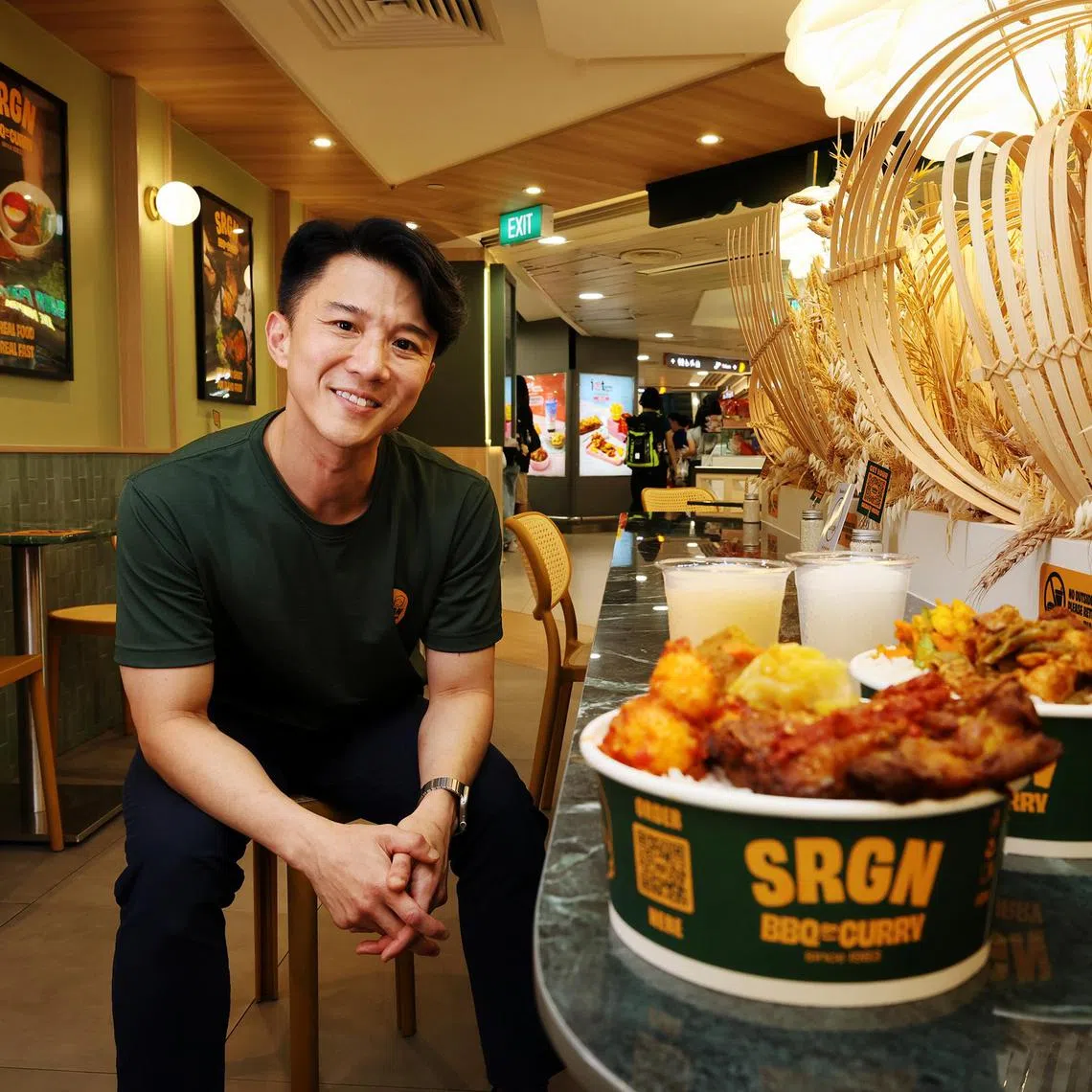 Mr Eugene Tan, co-owner of Serangoon BBQ & Curry, and nasi padang bowls sold at his outlets. 