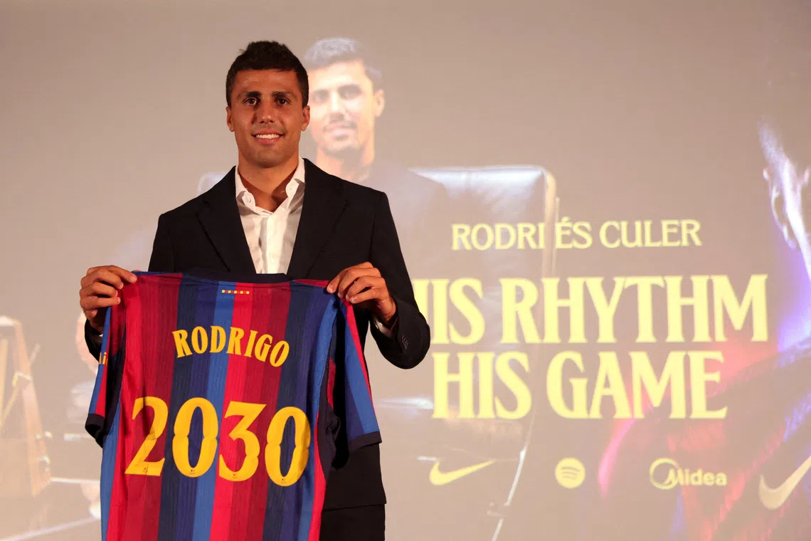 Rodri posing with his shirt during his presentation to the media at Barcelona on Aug 18.