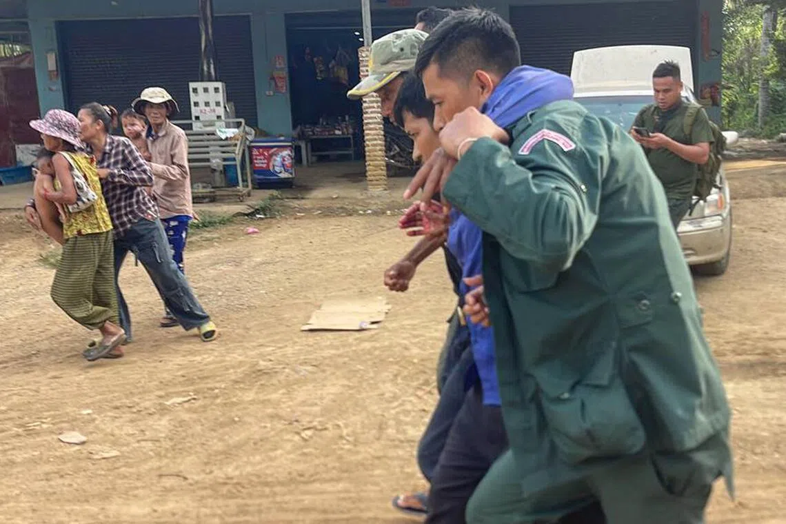An injured man being carried away in Cambodia's Banteay Meanchey province, amidst fresh clashes with Thailand, on Nov 12.