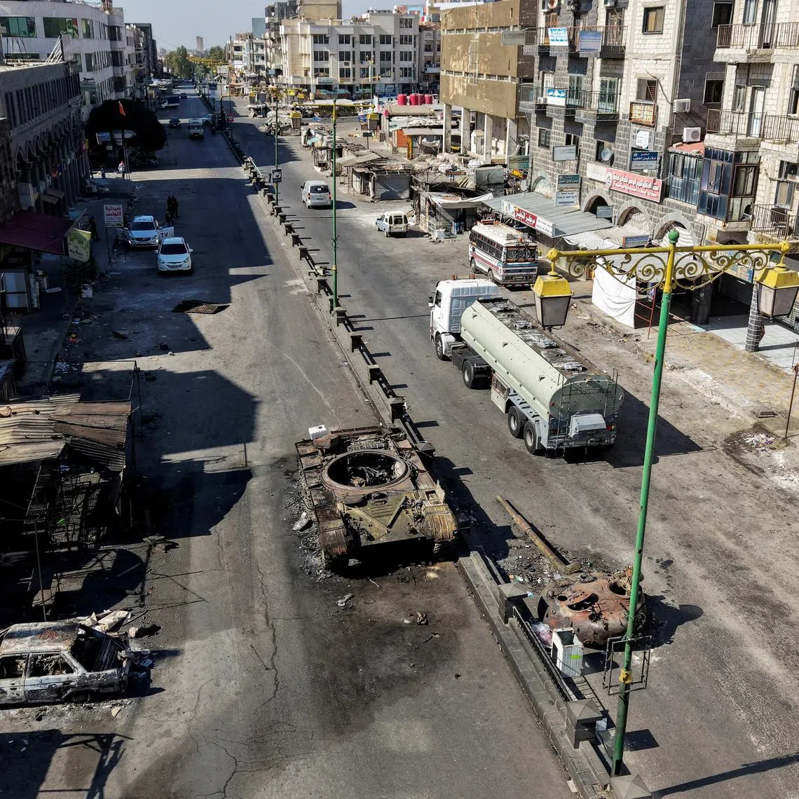 A drone view shows the remains of a destroyed tank, following deadly clashes between Druze fighters, Sunni Bedouin tribes and government forces, in Syria's predominantly Druze city of Sweida, Syria July 25, 2025. REUTERS/Khalil Ashawi/File Photo