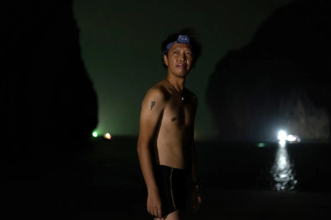 Wizchayuth Limungkoon, 41, a former ranger and current team member of the Maya Shark Watch Project, prepares to get into the water to pick up cameras installed at their baited remote underwater video station, in Maya Bay on February 25. 
