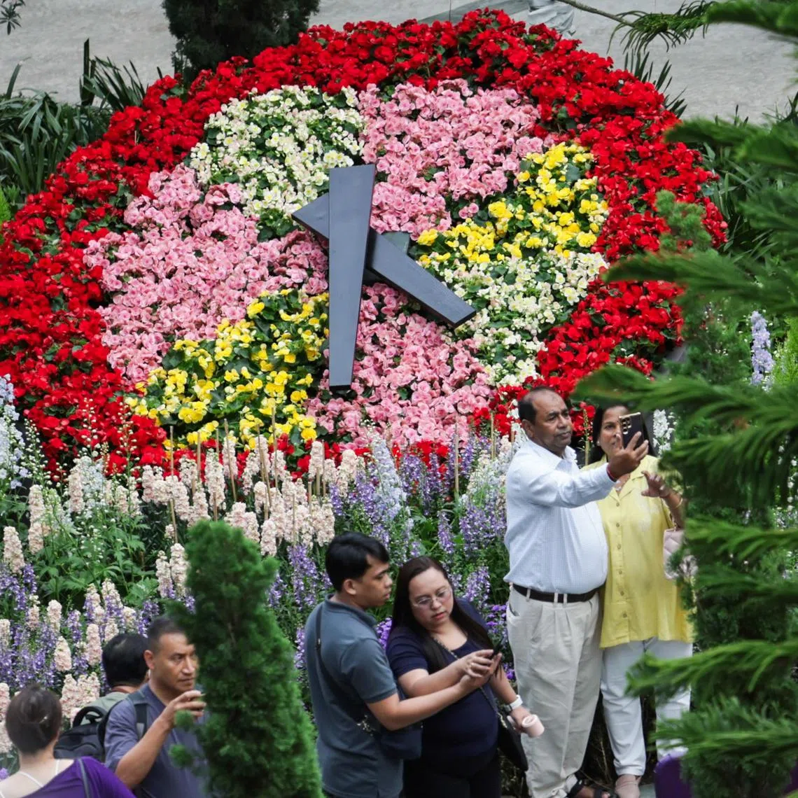 Tourists taking a photo of a replica of Geneva’s famed Flower Clock at Gardens by the Bay's Flower Dome on Sept 4.