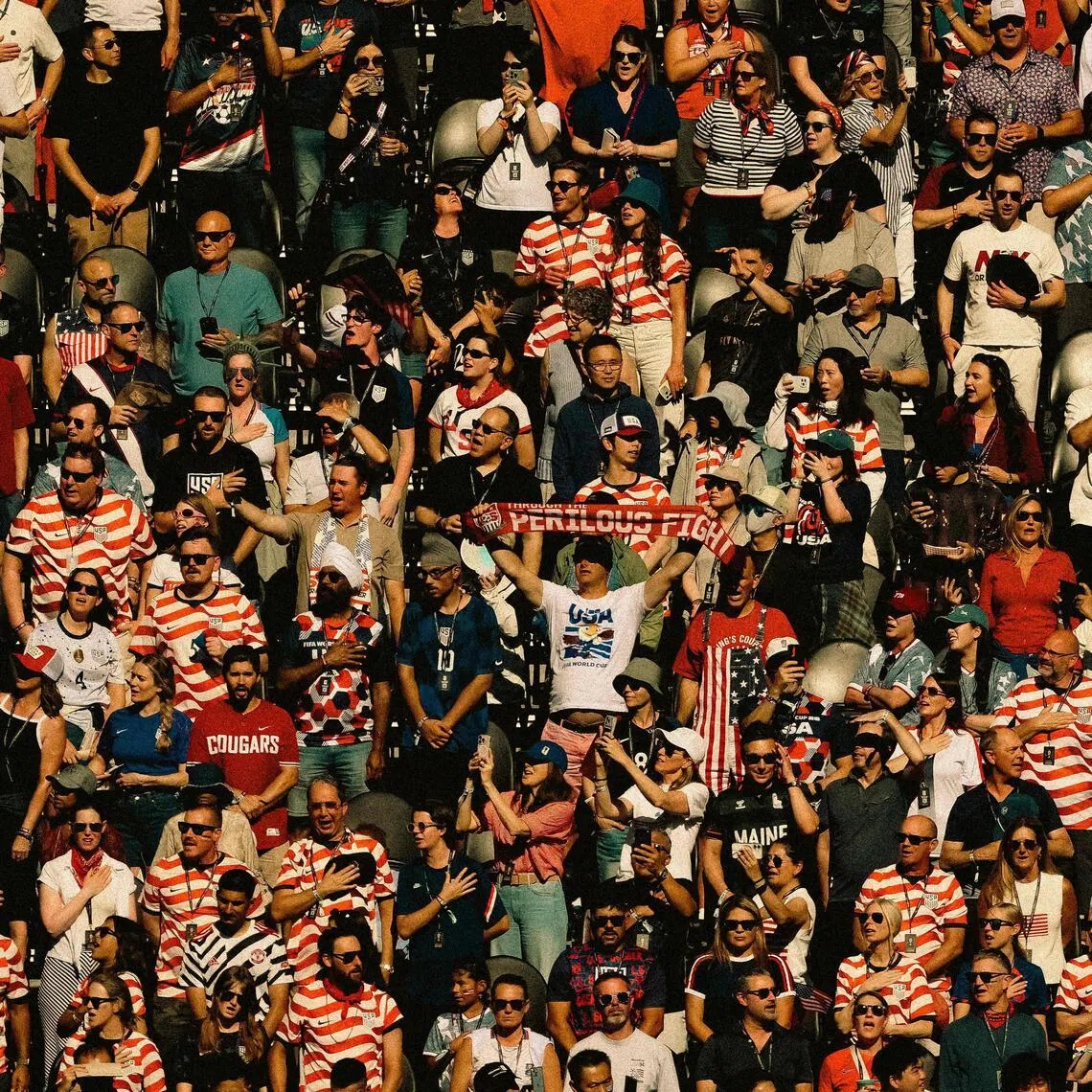 SEATTLE, WASHINGTON - JULY 06: (EDITOR'S NOTE: Tonal effects have been applied to this image) USA Fans stand for the national anthem during the FIFA World Cup 2026 Round Of 16 match between USA and Belgium at Seattle Stadium on July 06, 2026 in Seattle, Washington.   David Ramos/Getty Images/AFP (Photo by David Ramos / GETTY IMAGES NORTH AMERICA / Getty Images via AFP)