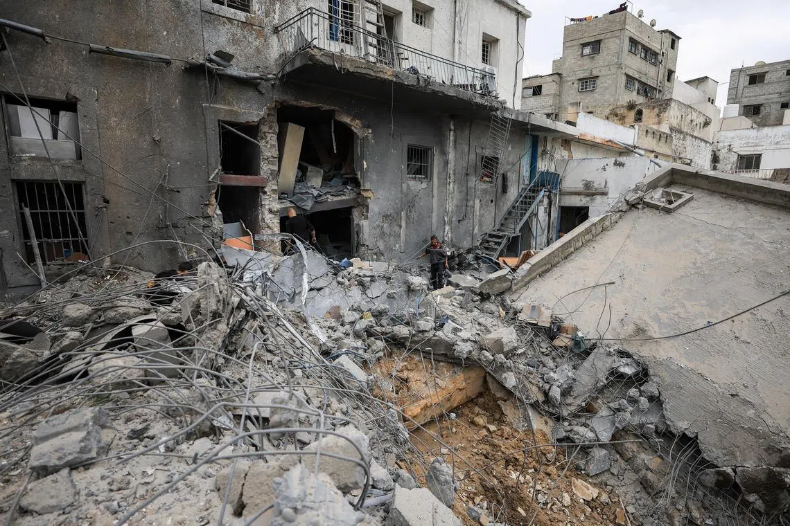 Palestinians inspect the damage after two Israeli missiles hit a building inside the Al-Ahli Arab Baptist Hospital, shortly after patients were evacuated following a call from someone who identified himself with Israeli security, in Gaza City, April 13, 2025. REUTERS/Dawoud Abu Alkas