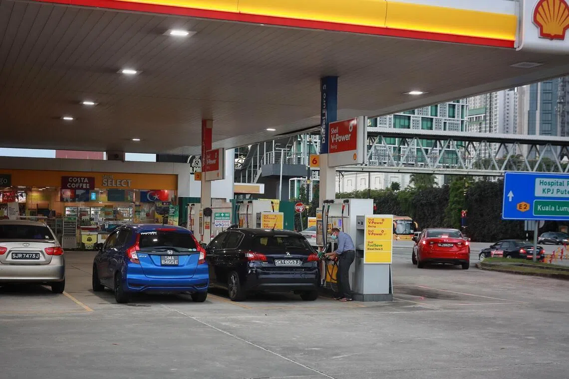 Singapore cars refuelling at a Shell petrol station in Johor Bahru.