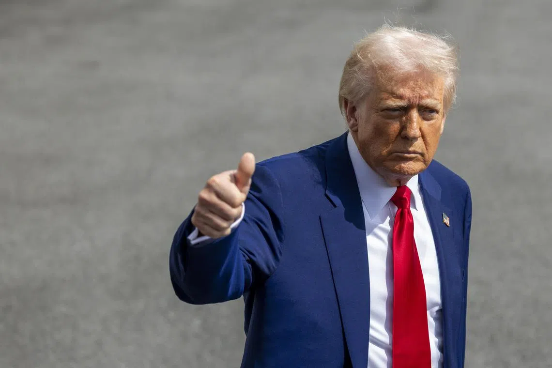 US President Donald Trump gesturing to members of the media as he heads to Florida for the weekend, on April 3. 