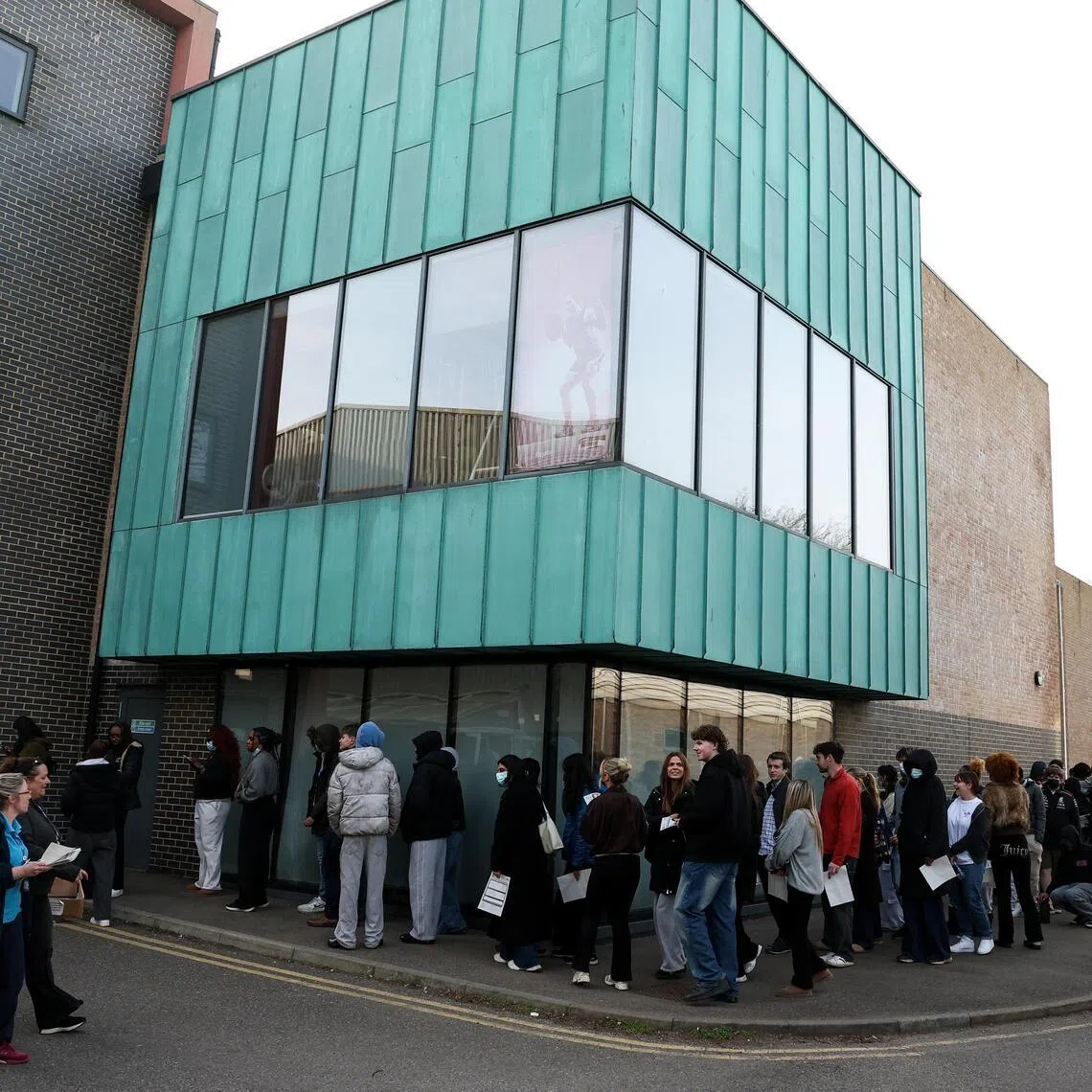 People, mainly students, queueing to receive Meningitis B vaccinations at a sports centre on the University of Kent campus on March 20, following an outbreak in Kent. 