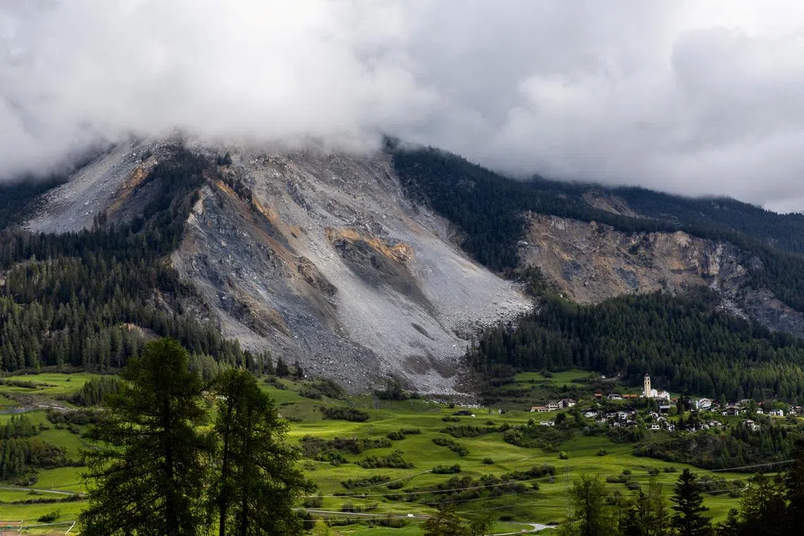 FILE PHOTO: Overview of the village and its church in front of the zone of rockslide on the day of the evacuation deadline, in Brienz, Switzerland, May 12, 2023. REUTERS/Denis Balibouse/File Photo
