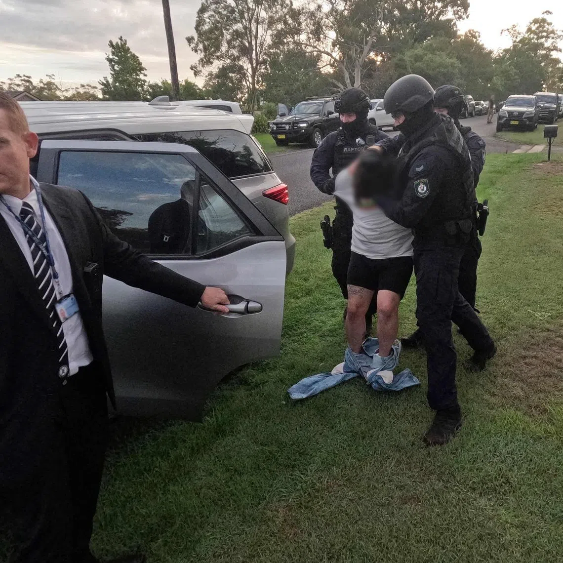 Officers detaining a man on Feb 25, following his arrest over the alleged kidnapping and murder of Mr Chris Baghsarian.