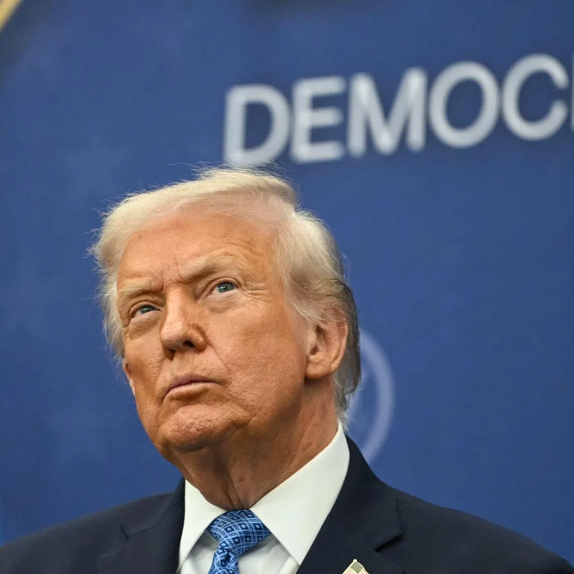 TOPSHOT - US President Donald Trump attends the signing ceremony of a peace deal with the President of Rwanda Paul Kagame and the President of the Democratic Republic of the Congo Felix Tshisekedi at the United States Institute of Peace in Washington, DC, on December 4, 2025. Trump on Thursday brings the leaders of Rwanda and the Democratic Republic of Congo together to endorse a deal that Trump has hailed as his latest peace triumph despite ongoing violence on the ground. Trump hopes the agreement will pave the way for the United States to gain access to critical minerals in the eastern DRC, a violence-torn region home to many of the key ingredients in modern technologies such as electric cars. (Photo by ANDREW CABALLERO-REYNOLDS / AFP)