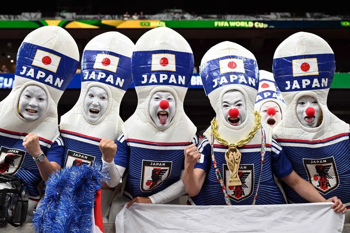 TOPSHOT - Japan's supporters pose ahead of the 2026 World Cup round of 32 football match between Brazil and Japan at the Houston Stadium in Houston on June 29, 2026.  (Photo by Paul ELLIS / AFP)