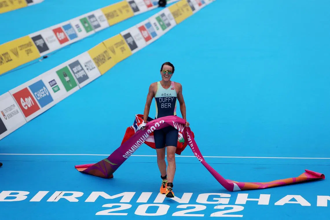 FILE PHOTO: Commonwealth Games - Triathlon - Women's Individual Sprint Distance Final - Sutton Park, Birmingham, Britain - July 29, 2022 Bermuda's Flora Duffy crosses the line to win the women's individual sprint distance final REUTERS/Stoyan Nenov