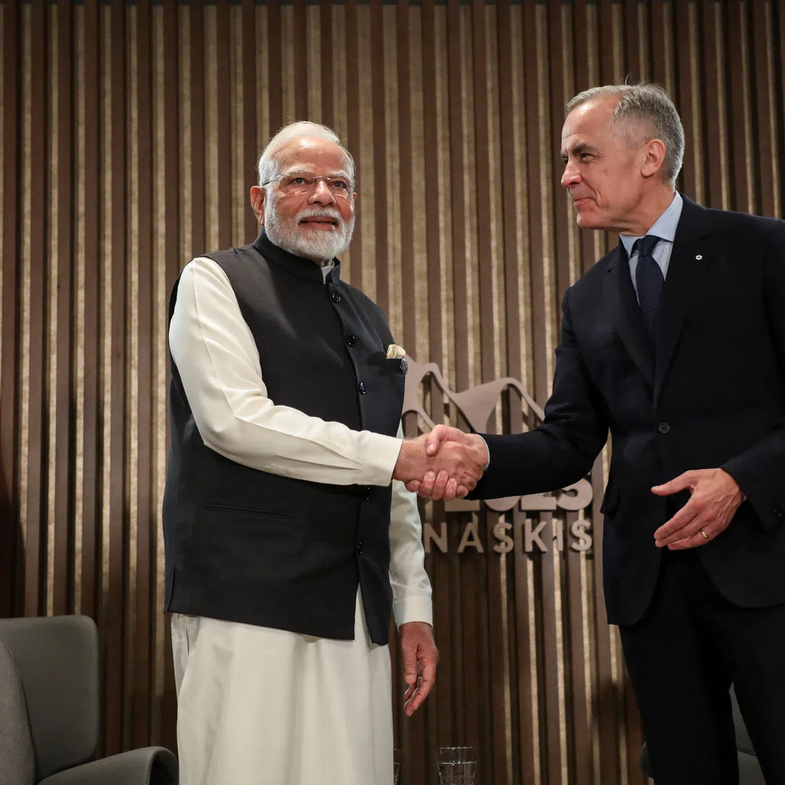 Indian Prime Minister Narendra Modi shakes hands with Canadian Prime Minister Mark Carney as they hold a bilateral meeting during the G7 Leader's Summit in Kananaskis, Alberta, Canada June 17, 2025. REUTERS/Amber Bracken