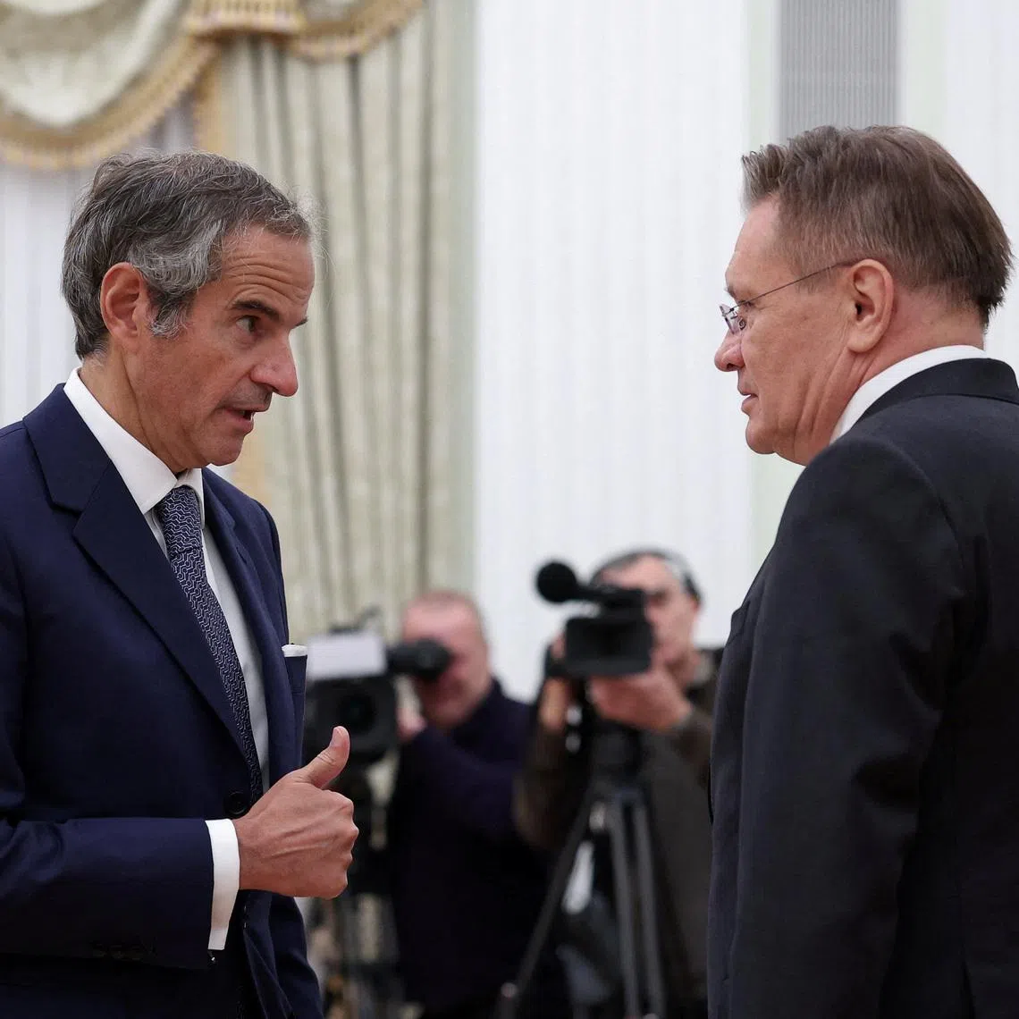 Director General of Russia's State Atomic Energy Corporation Rosatom Alexei Likhachev and Director General of the International Atomic Energy Agency (IAEA) Rafael Grossi speak as they attend a meeting with Russia's President Vladimir Putin at the Kremlin in Moscow, Russia, September 25, 2025. REUTERS/Ramil Sitdikov/Pool/File Photo