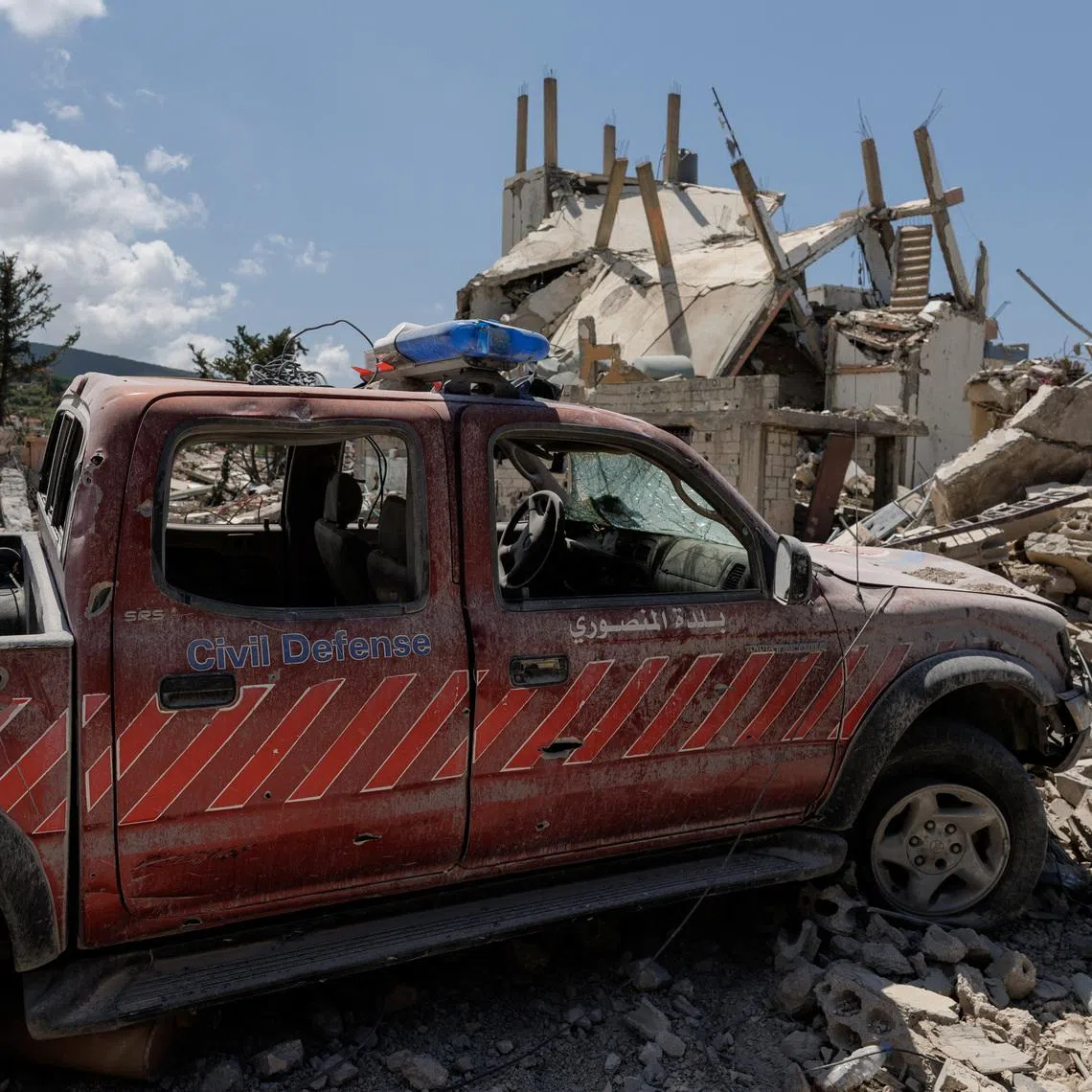FILE PHOTO: A damaged civil defence car parks in front of a house damaged by an Israeli strike, amid a 10-day ceasefire between Lebanon and Israel, in Mansouri village, southern Lebanon, April 21, 2026. REUTERS/Zohra Bensemra/File Photo