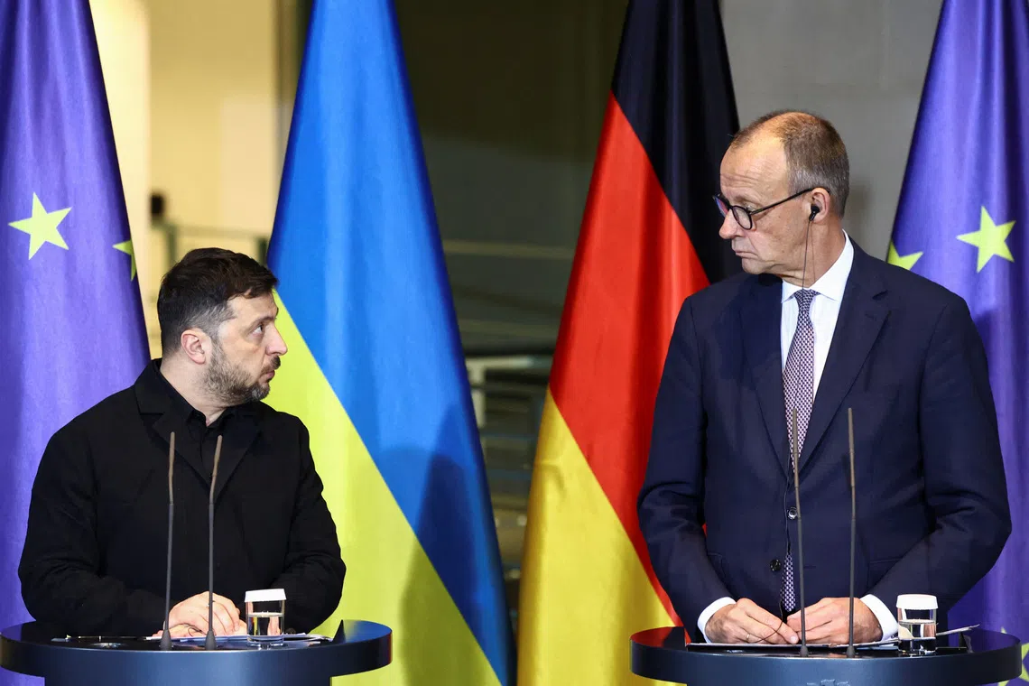 German Chancellor Friedrich Merz and Ukrainian President Volodymyr Zelenskiy hold a press conference at the Chancellery in Berlin, Germany December 15, 2025. REUTERS/Liesa Johannssen