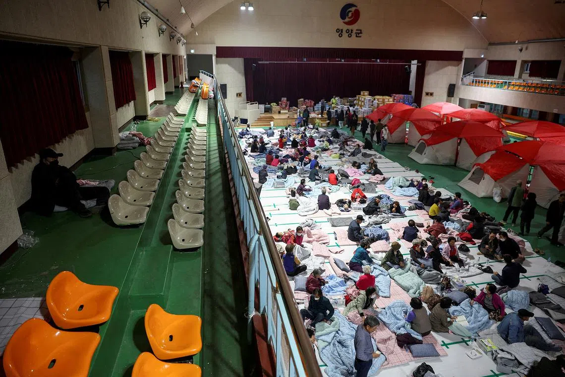 People resting at a shelter after wildfire devastated the area in Yeongyang, South Korea, on March 26, 2025. 