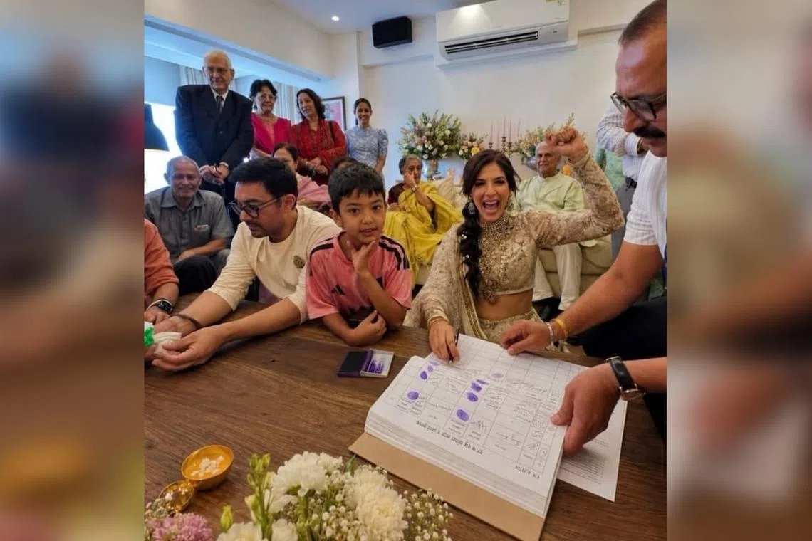Aamir Khan (sitting, in white) and Gauri Spratt (with hand raised) tied the knot on July 5.