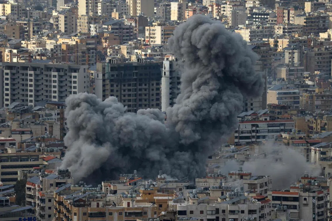 TOPSHOT - Smoke rises from the site of Israeli airstrikes that targeted Beiruts southern suburbs on November 25, 2024, amid the ongoing war between Israel and Hezbollah. (Photo by IBRAHIM AMRO / AFP)