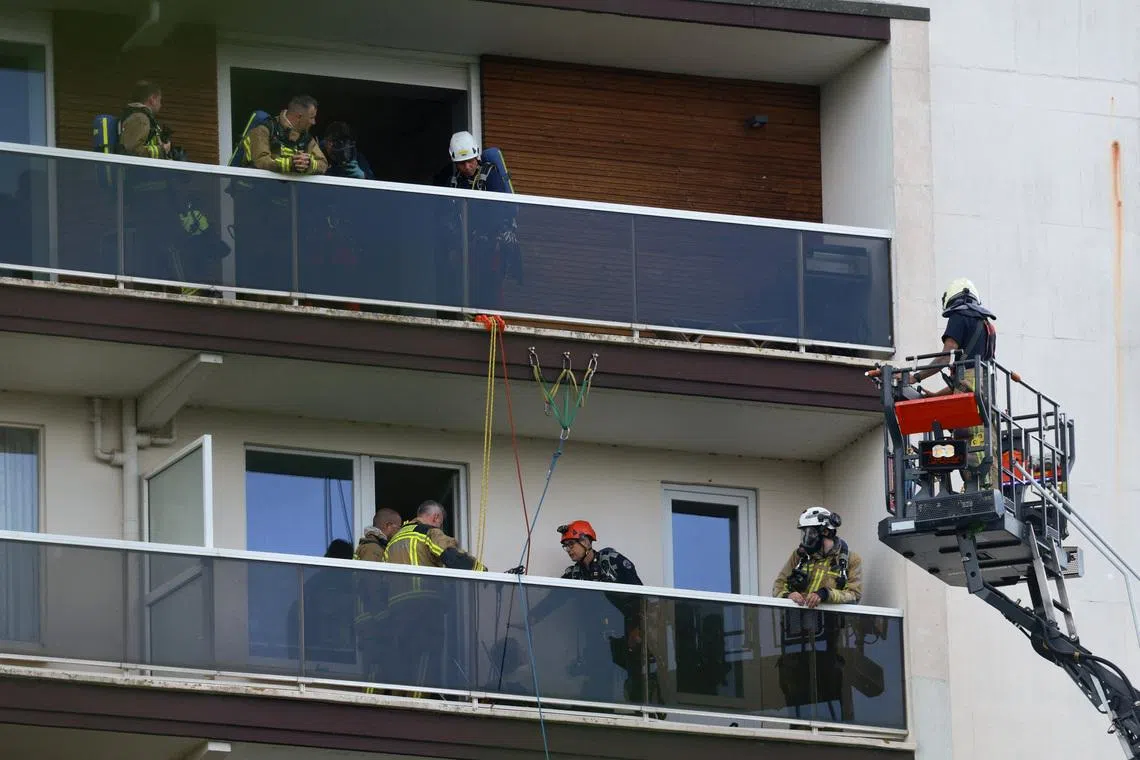 Rescuers work at the site of a fire in a housing building in Antwerp, Belgium, July 1.