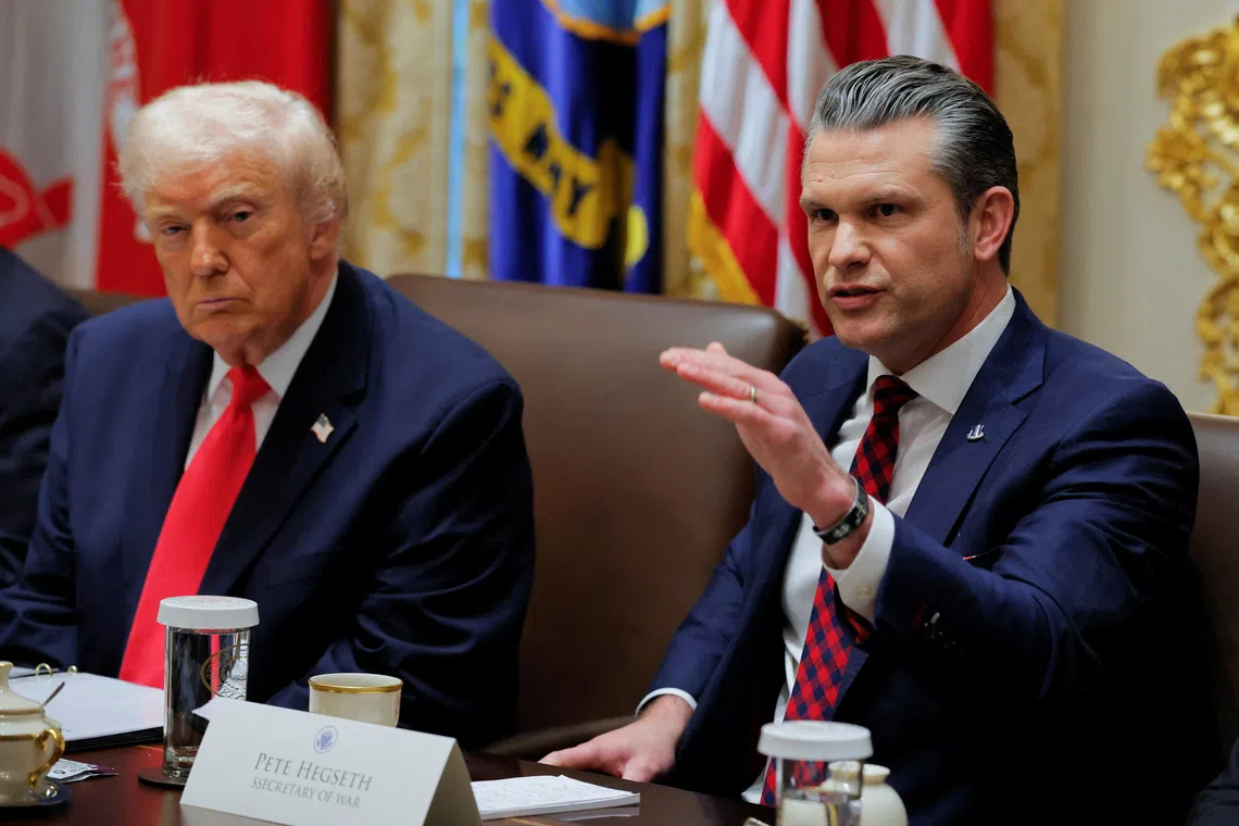 US Secretary of Defense Pete Hegseth (right) at a cabinet meeting with US President Donald Trump on Dec 2.
