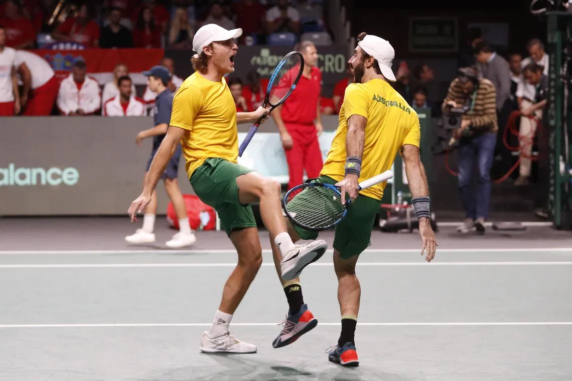 Australian pair of Jordan Thompson (right) and Max Purcell celebrate their victory against Croatia's Nikola Mektic and Mate Pavic during their Davis Cup semi-final match in Malaga on Nov 25.