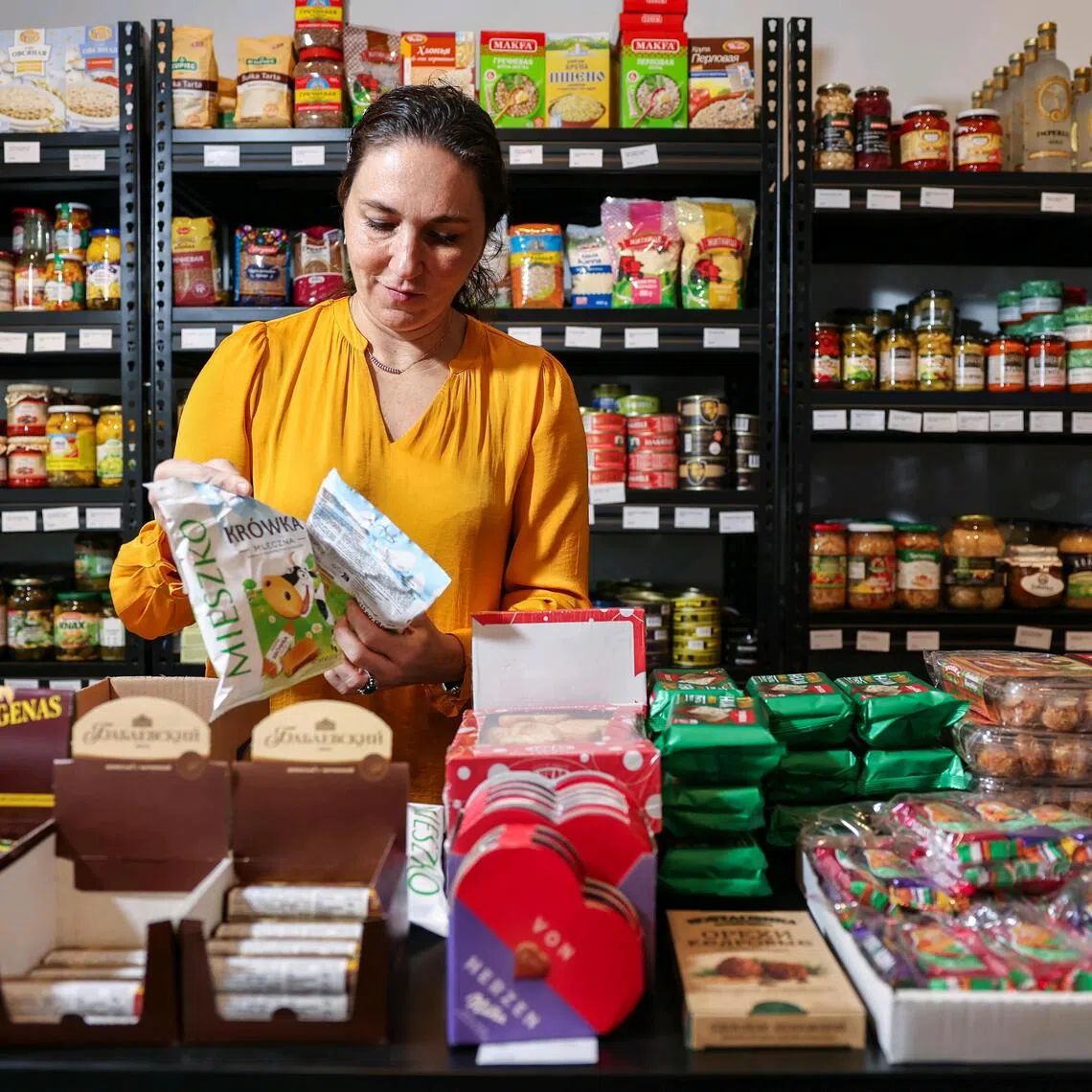 Anna Jaeger, owner of Anna’s Gourmet, arranging the products at her store at Jalan Merah Saga.