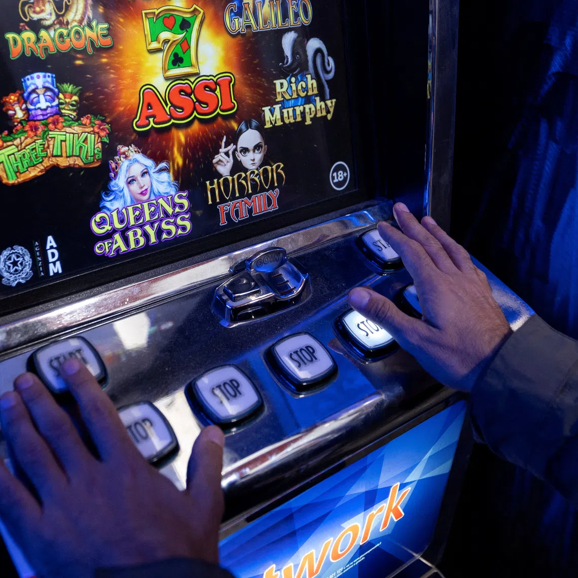 A man plays a slot machine in a shop in Rome, Italy, October 29, 2025. REUTERS/Remo Casilli