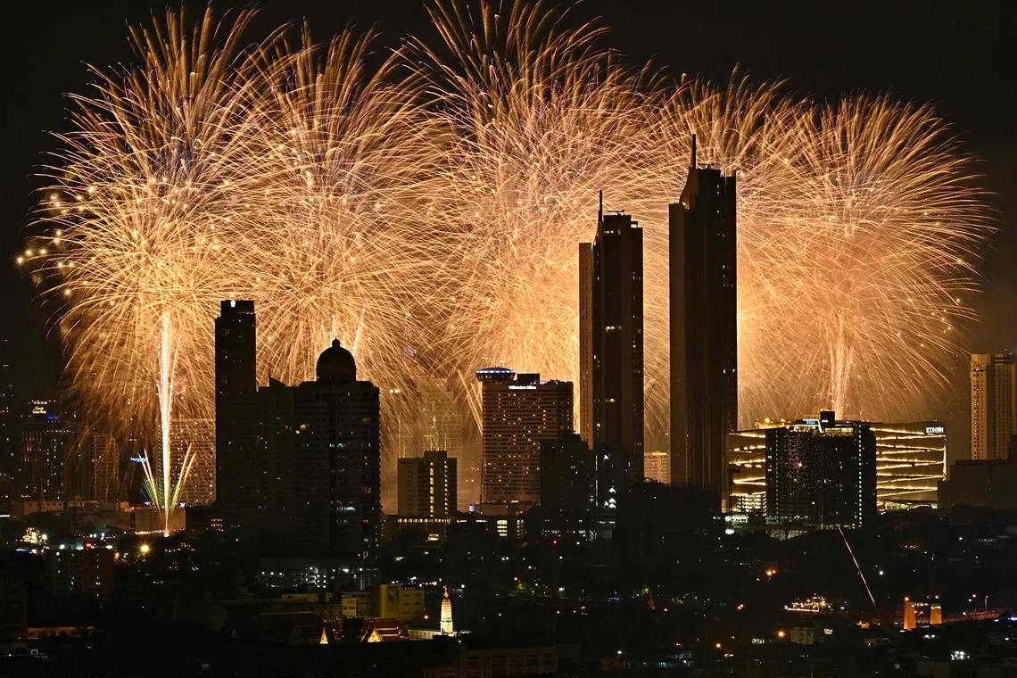 Fireworks exploding over the city skyline along the Chao Phraya River during New Year’s Eve celebrations in Bangkok on Jan 1, 2024. 