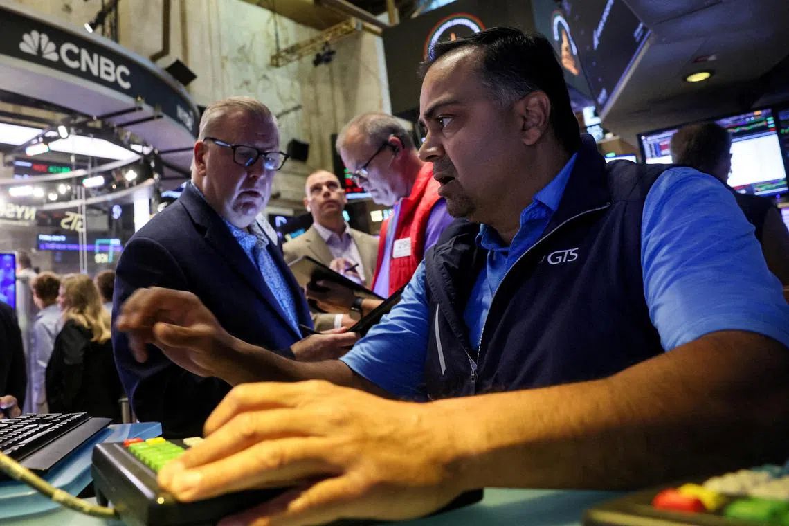 Traders work on the floor of the New York Stock Exchange, in New York City.