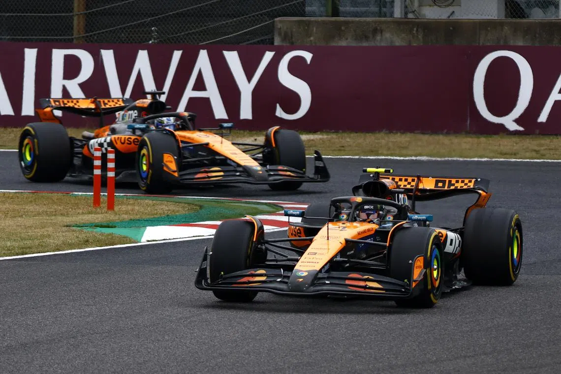 Formula One F1 - Japanese Grand Prix - Suzuka Circuit, Suzuka, Japan - April 6, 2025 McLaren's Lando Norris and McLaren's Oscar Piastri in action during the race REUTERS/Manami Yamada