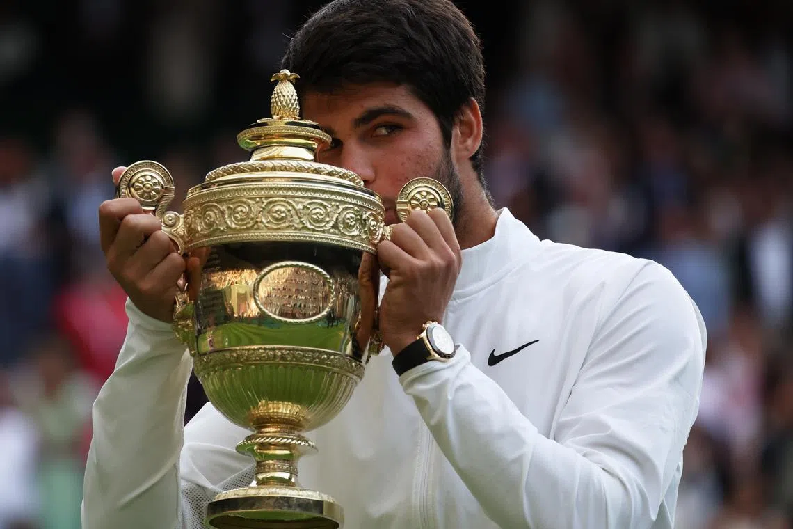 Carlos Alcaraz of Spain poses with the trophy after winning his Men's Singles final match against Novak Djokovic.