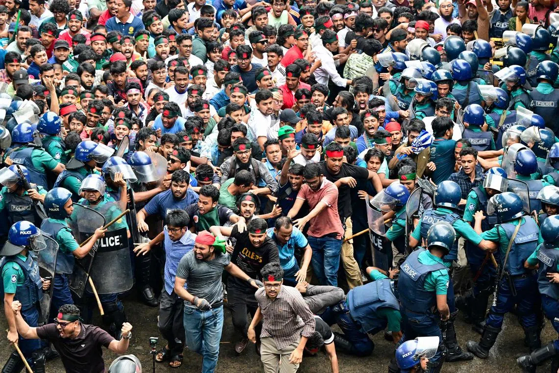 Students scuffling with police during a protest to demand merit-based system for civil service jobs in Dhaka, on July 11, 2024. 