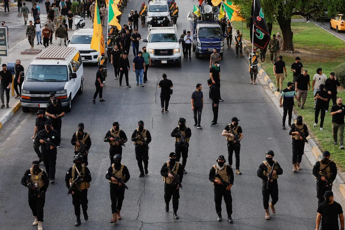 FILE PHOTO: A vehicle carries the coffin of a commander from Iraq's Kataib Hezbollah armed group who was killed in what they called a \"Zionist attack\" in the Syrian capital Damascus on Friday, during a funeral in Baghdad, Iraq September 22, 2024. REUTERS/Thaier Al-Sudani/File Photo