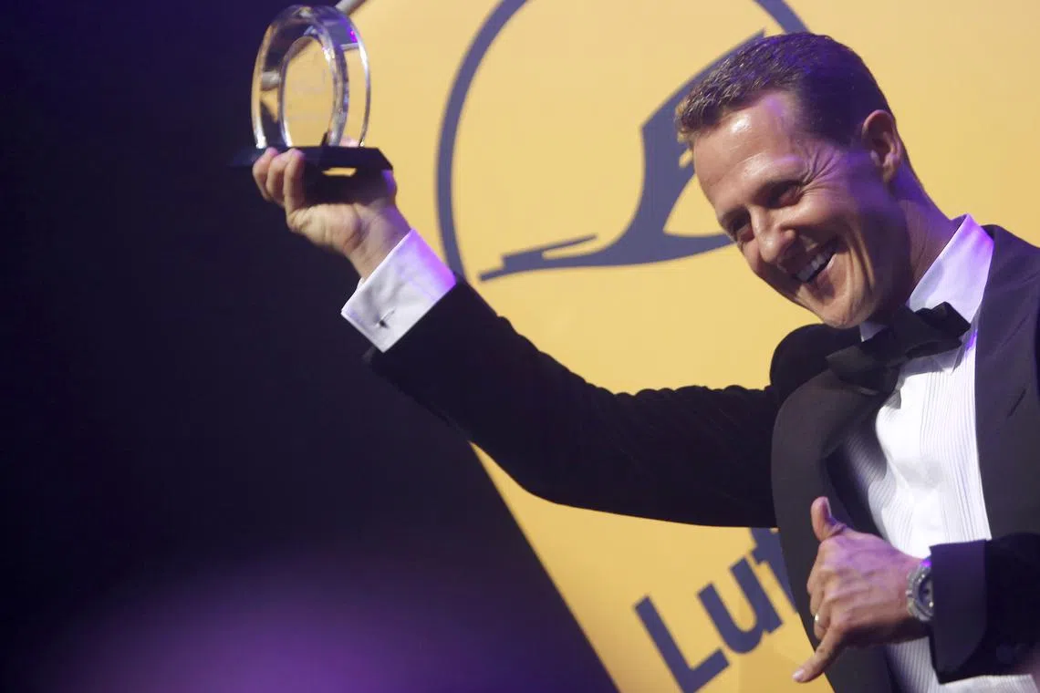 FILE PHOTO: German Formula One driver Michael Schumacher poses with the Legend of Sport trophy at the German Sports Press Ball in Frankfurt November 10, 2012.  REUTERS/Lisi Niesner/File Photo