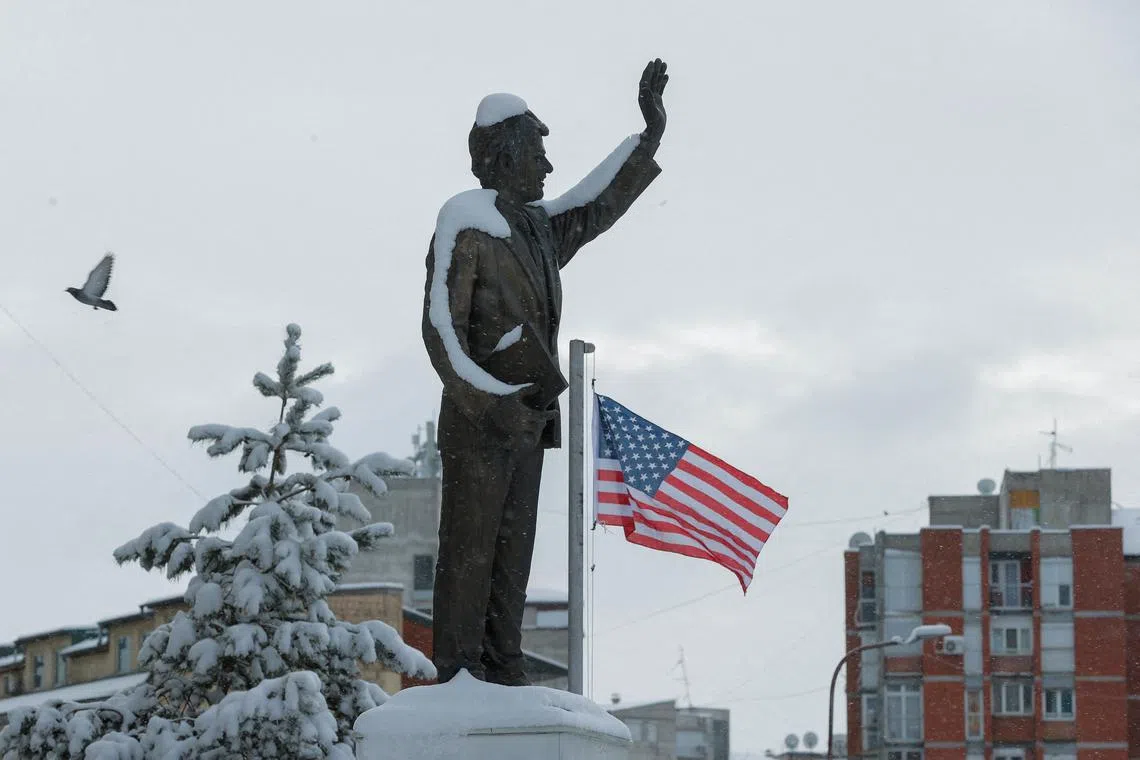 FILE PHOTO: A statue of former U.S. President Bill Clinton is covered by snow at a boulevard named after him, in Pristina, Kosovo January 11, 2025. REUTERS/Valdrin Xhemaj/ File Photo