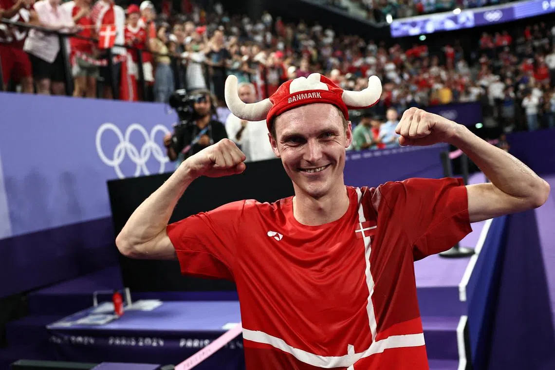 Viktor Axelsen of Denmark posing after winning gold in the Paris Olympics badminton men's singles final against Kunlavut Vitidsarn of Thailand at Porte de La Chapelle Arena on Aug 5.