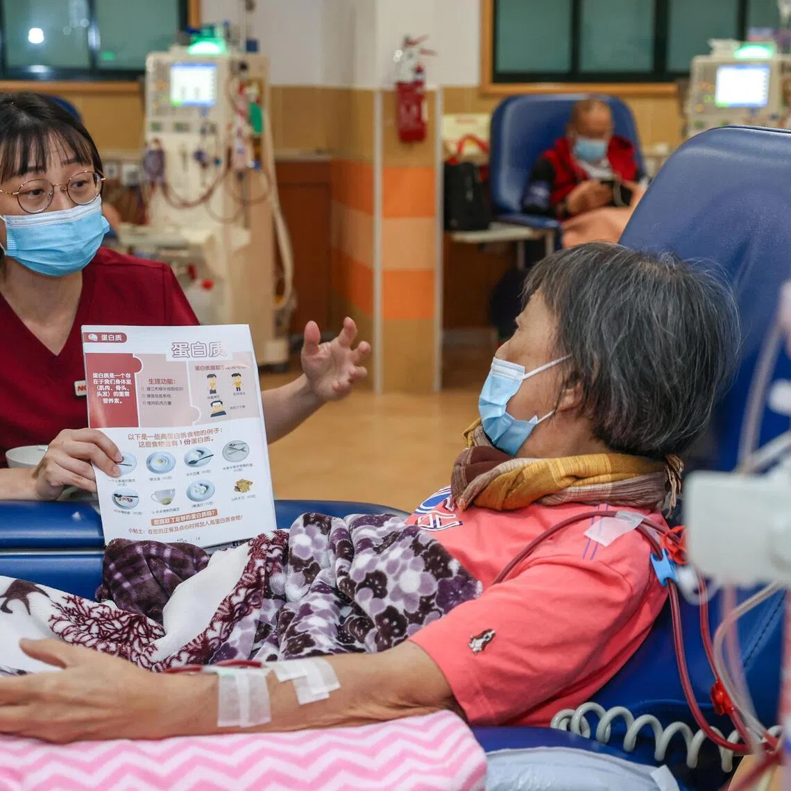 NKF principal dietitian Yee Chooi Fong explaining protein requirements to Neo Ah Lek at NKF’s 633 Ang Mo Kio Dialysis Centre on June 24.